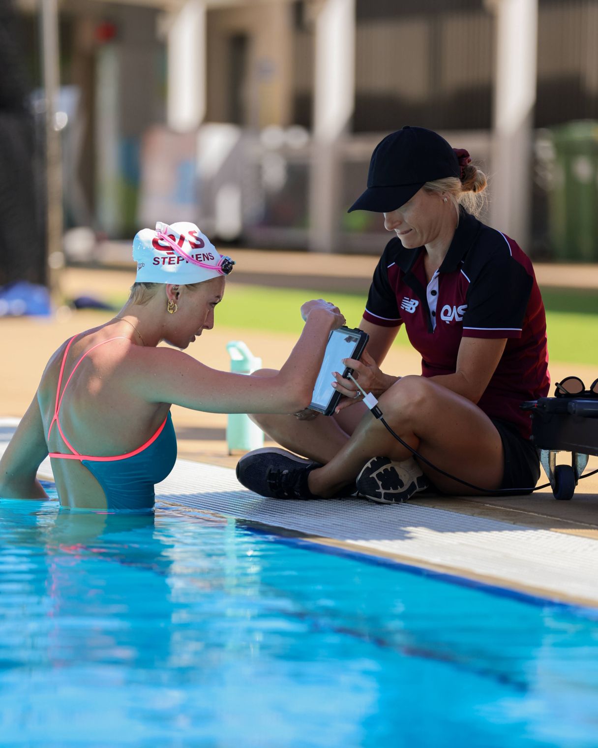 QAS staff member and athlete discussing performance, wellbeing and development goals.