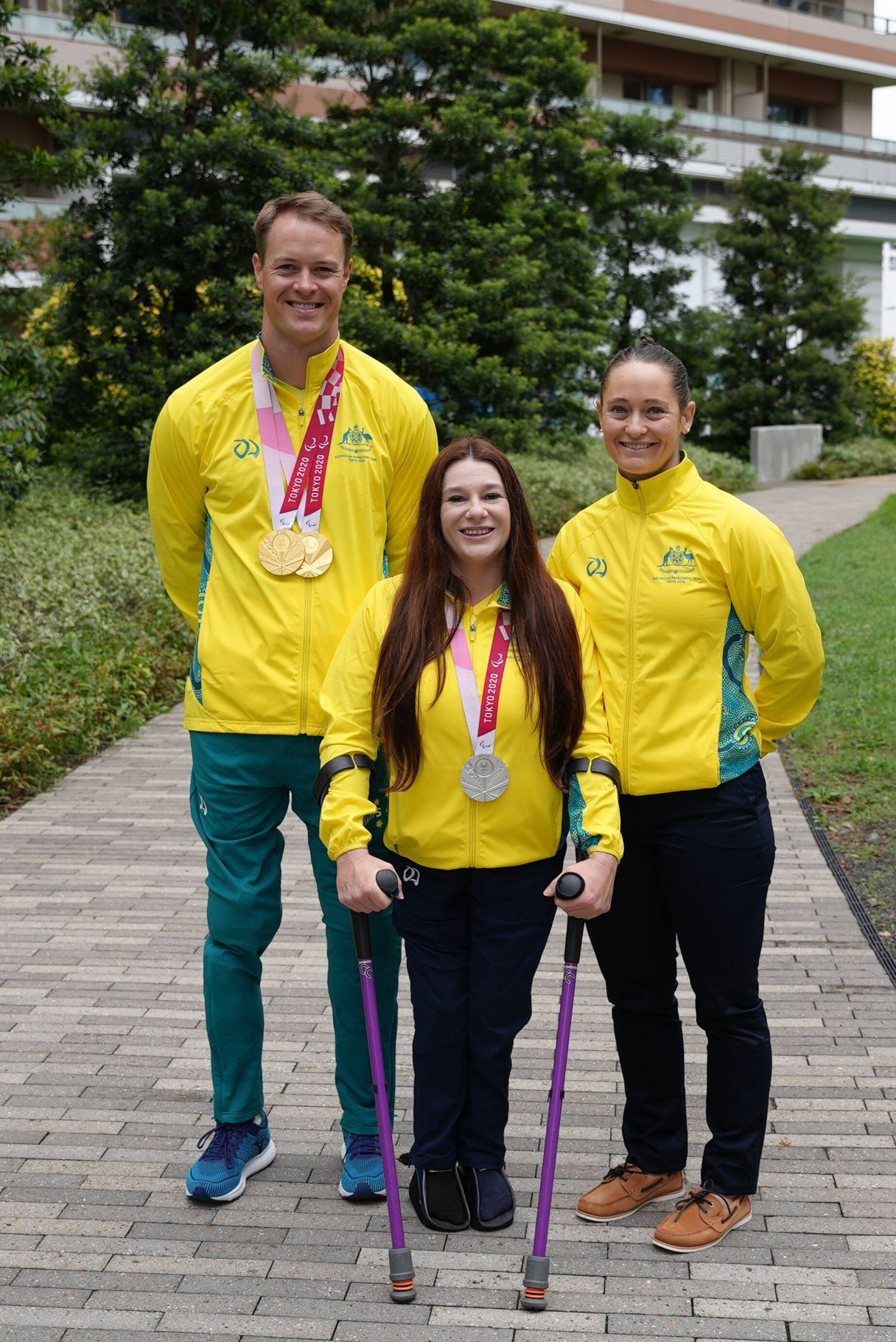 Susan Seipel stands with Paralympian Kurtis McGrath and physio Kate O’Connell at the 2020 Tokyo Paralympics.