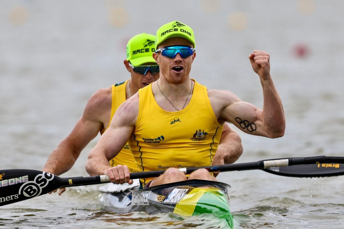 Tom Green and Jean van der Westhuyzen celebrate in the kayak after finishing their world cup race.