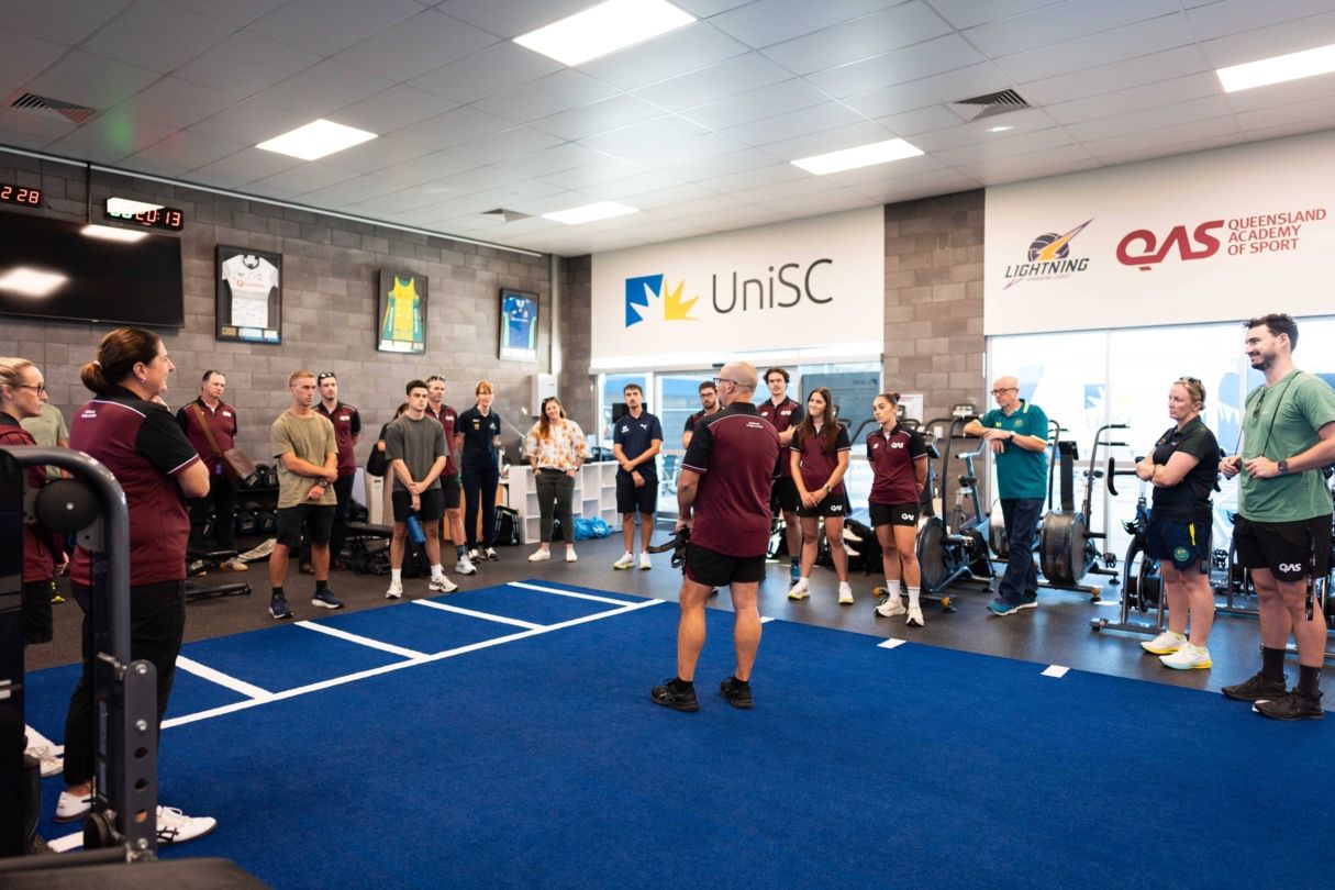 Gen2032 coaches participating in a coach development session at a QAS training facility.