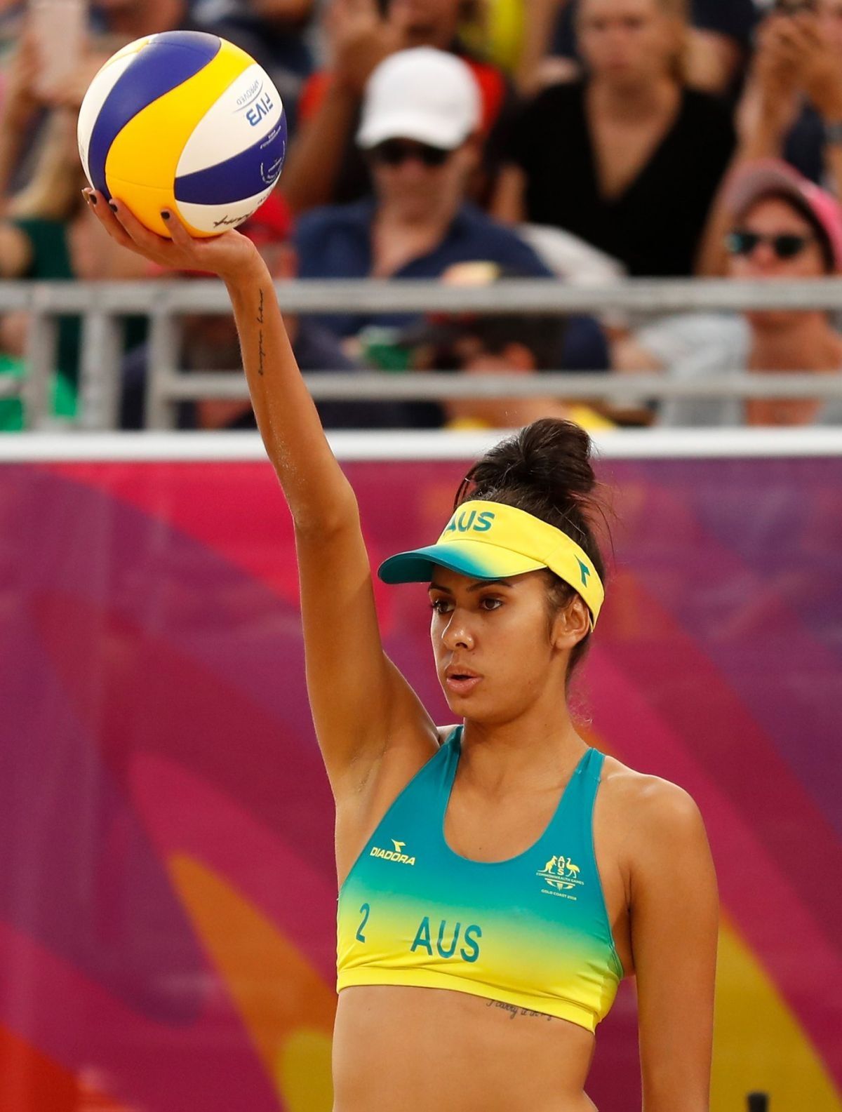 Taliqua Clancy raising ball in air ready to play beach volleyball at Paris 2024 Olympic Games