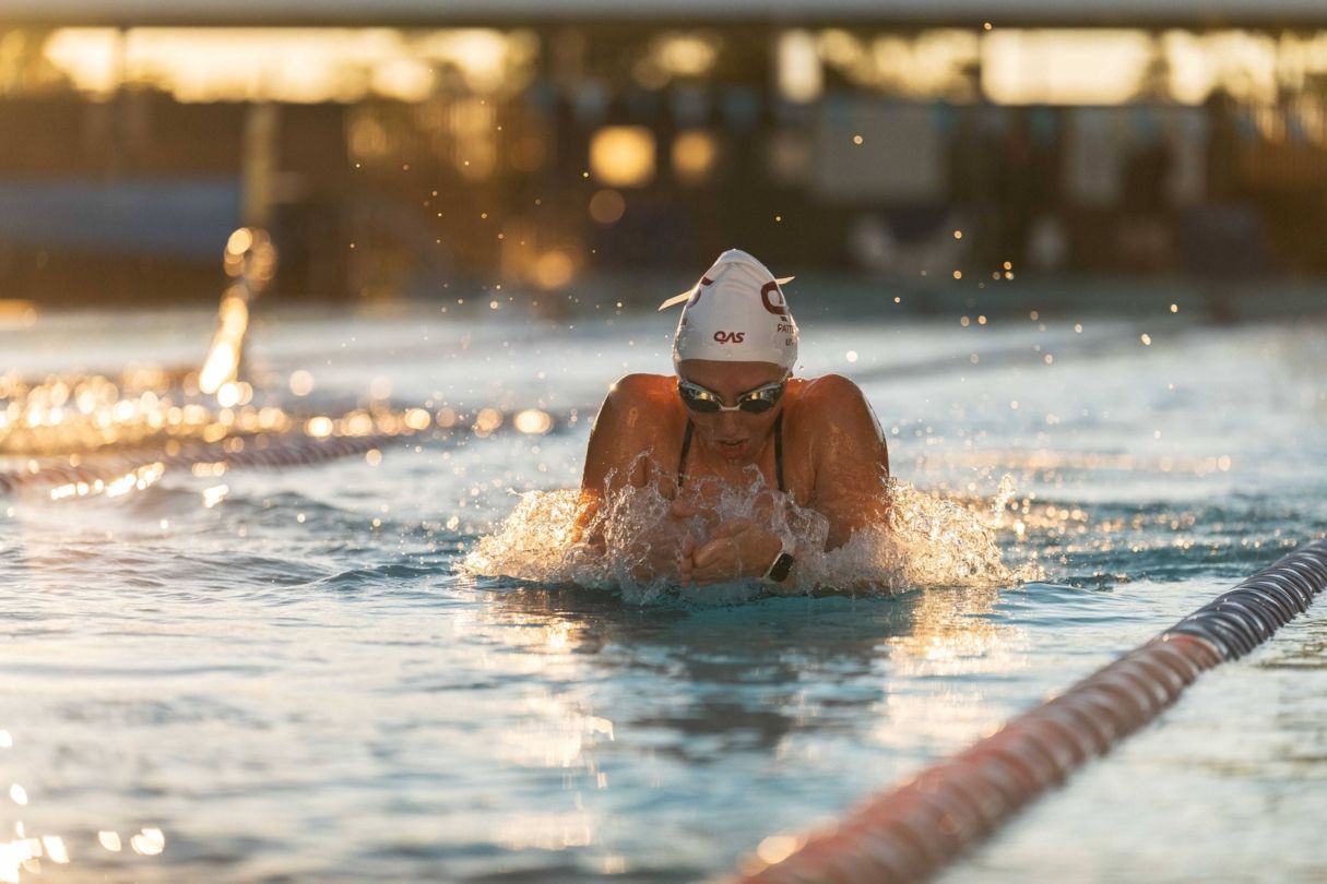 A female swimmer breaks through the water during a breaststroke training session ahead of the 2026 Commonwealth Games.