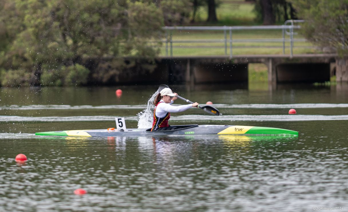 Susan Seipel kayaking through the water in a competition