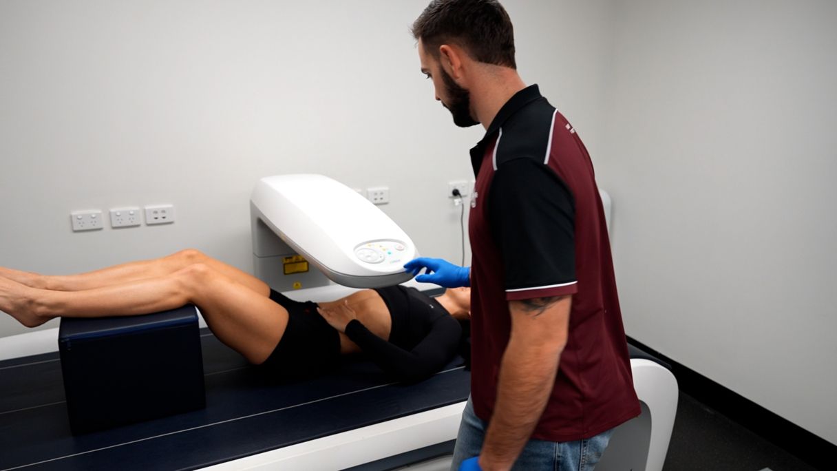 QAS athlete being scanned on DEXA machine operated by QAS scholar