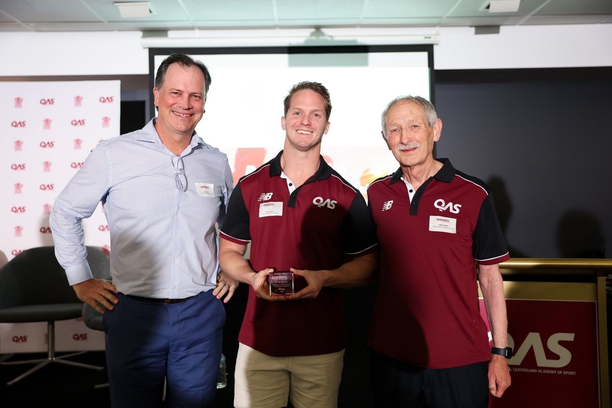 QAS staff members and a QAS Scholar smiling for a photo at the Research & Innovation Summit