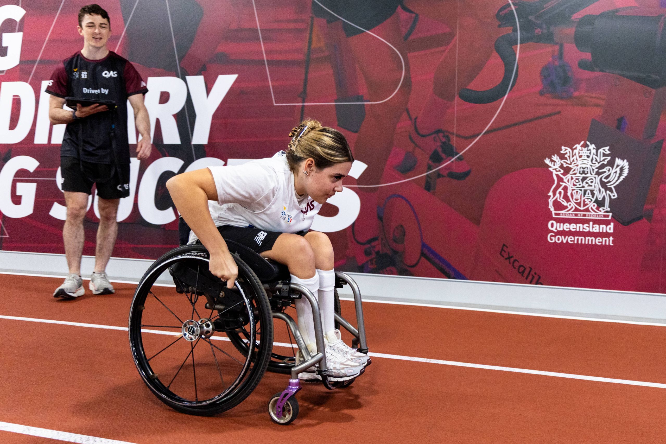 Athlete in wheelchair takes part in a speed exercise at the QAS with a YouFor2032 Talent Advisor.